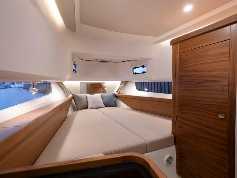 Slide: The Image of Luxurious interior cabin of 2025 Nimbus C11 boat with cozy bed and wooden accents. - 33