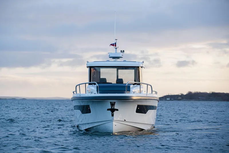 Slide: The Image of Nimbus C11 2025 boat on open water, front view under cloudy sky. - 6