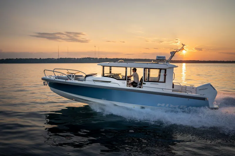 Slide: The Image of Nimbus C9 2025 boat cruising at sunset on calm waters. - 1