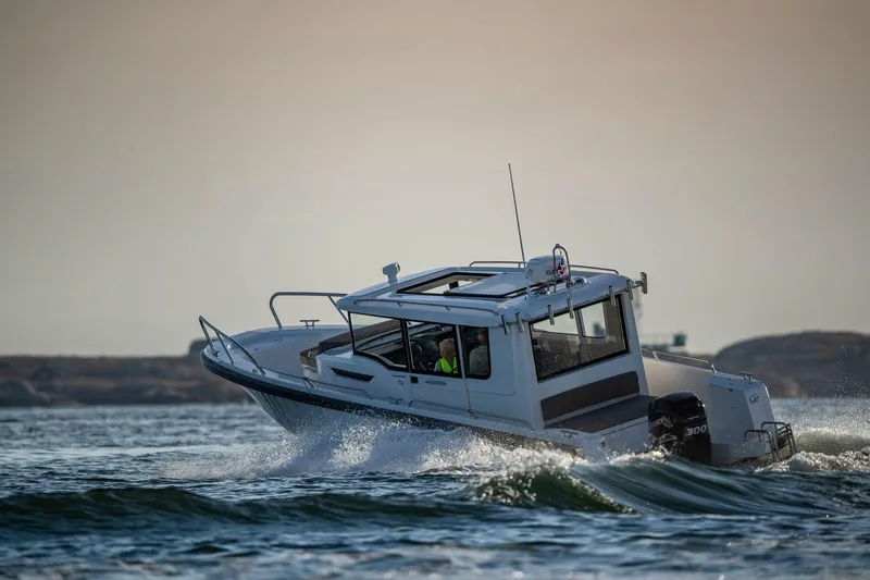 Slide: The Image of Nimbus C9 2025 boat navigating choppy waters at sunset. - 2