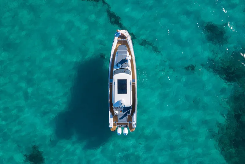 Slide: The Image of Aerial view of 2025 Nimbus Tender 11 boat on clear turquoise water. - 14