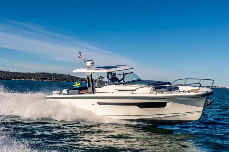 Slide: The Image of Nimbus Tender 11, 2025 model, cruising on open water under clear blue skies. - 18