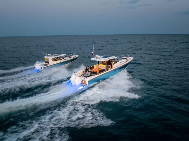Slide: The Image of Two Nimbus Tender 11 boats cruising on open water at sunset, 2025 model. - 23