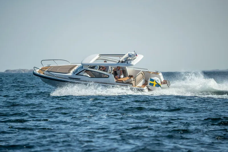 Slide: The Image of Nimbus Weekender 9 boat cruising on open water, 2025 model. - 2