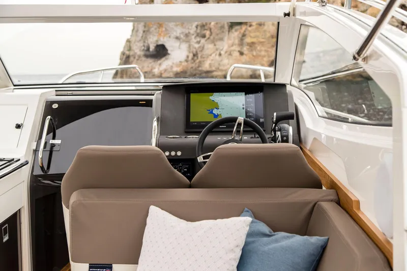 Slide: The Image of Interior of 2025 Nimbus Weekender 9 boat with navigation system and comfortable seating. - 20