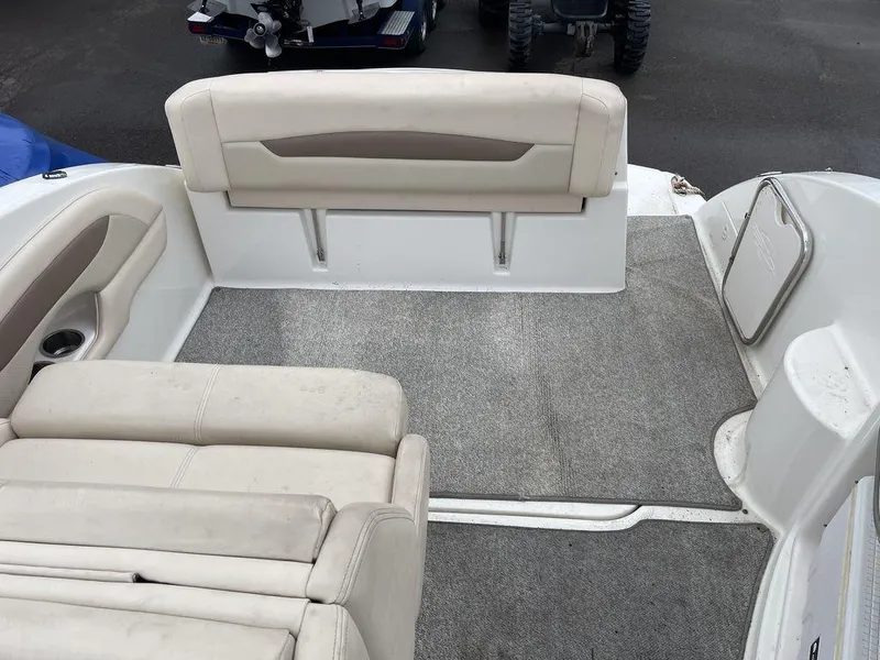 Slide: The Image of 2007 Chaparral 250 Signature boat interior with beige seating and gray carpet. - 10