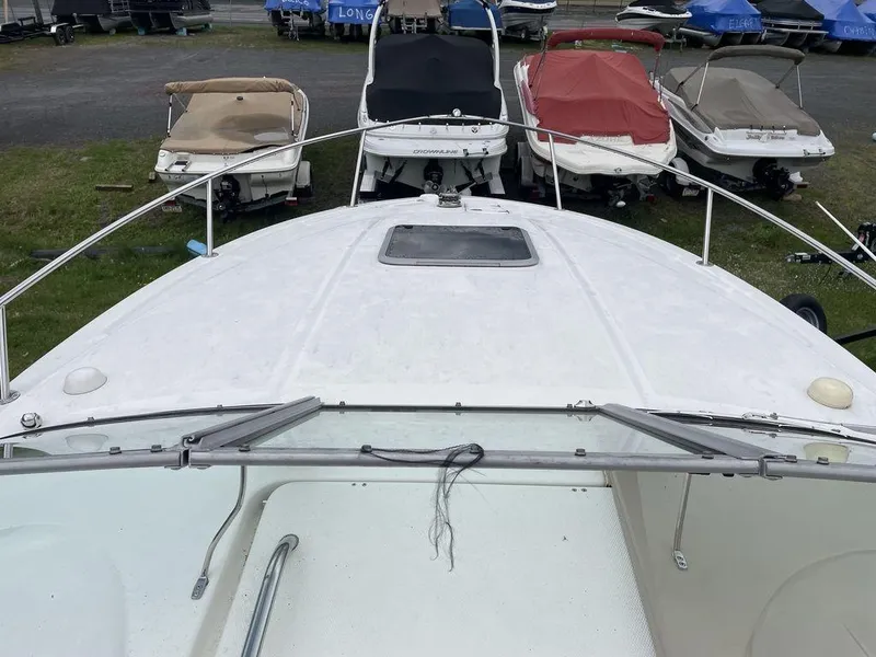 Slide: The Image of 2007 Chaparral 250 Signature boat docked with other vessels in a marina. - 2