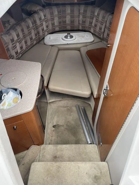 Slide: The Image of 2007 Chaparral 250 Signature cabin interior with seating and table. - 6