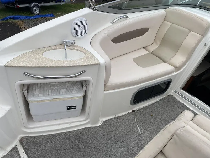 Slide: The Image of 2007 Chaparral 250 Signature boat interior with seating, sink, and storage compartment. - 9