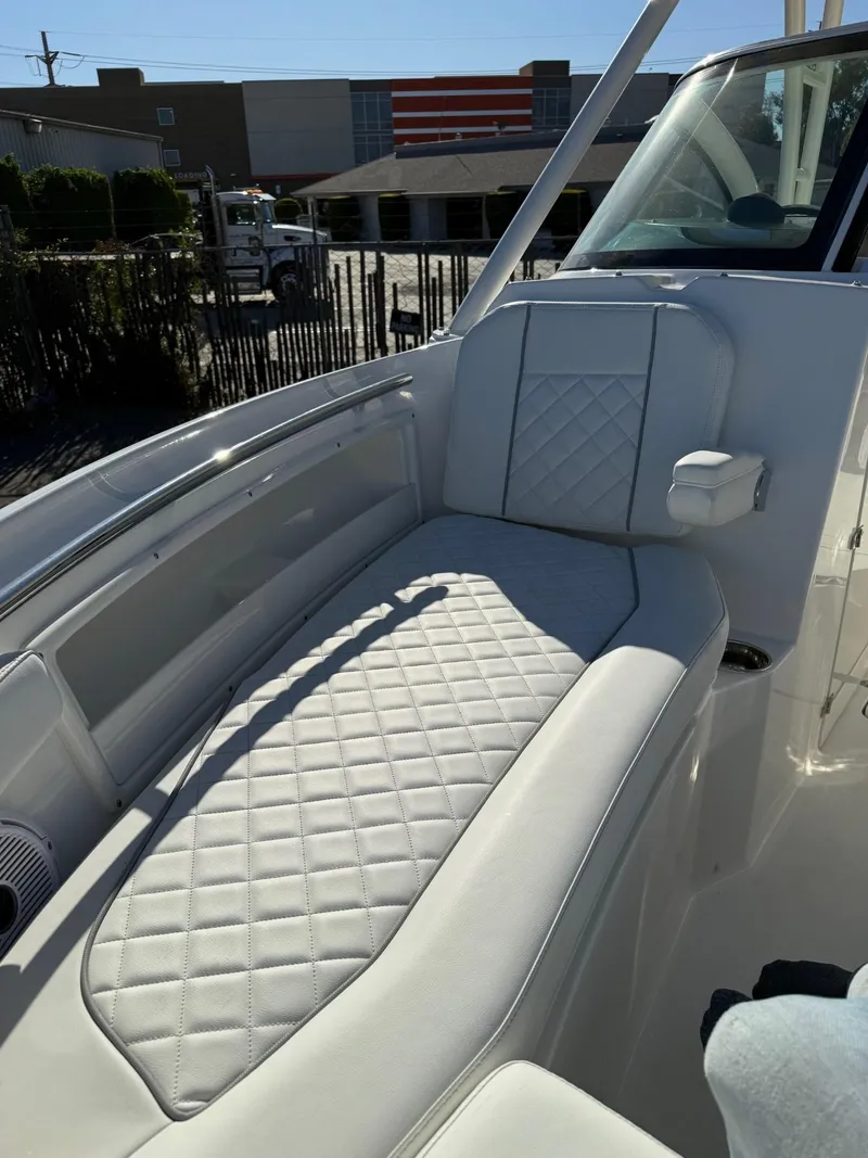 Slide: The Image of 2025 Pursuit DC 246 Dual Console boat with luxurious quilted seating. - 12