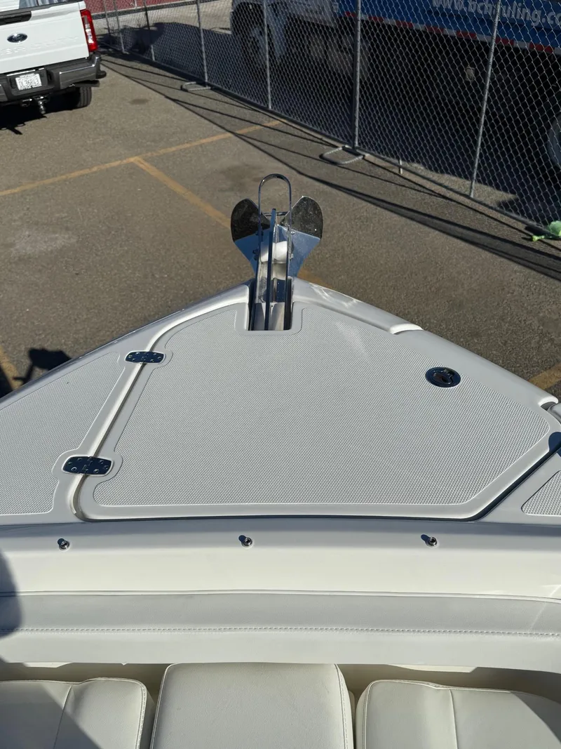 Slide: The Image of 2025 Pursuit DC 246 Dual Console boat bow with anchor in parking lot. - 14