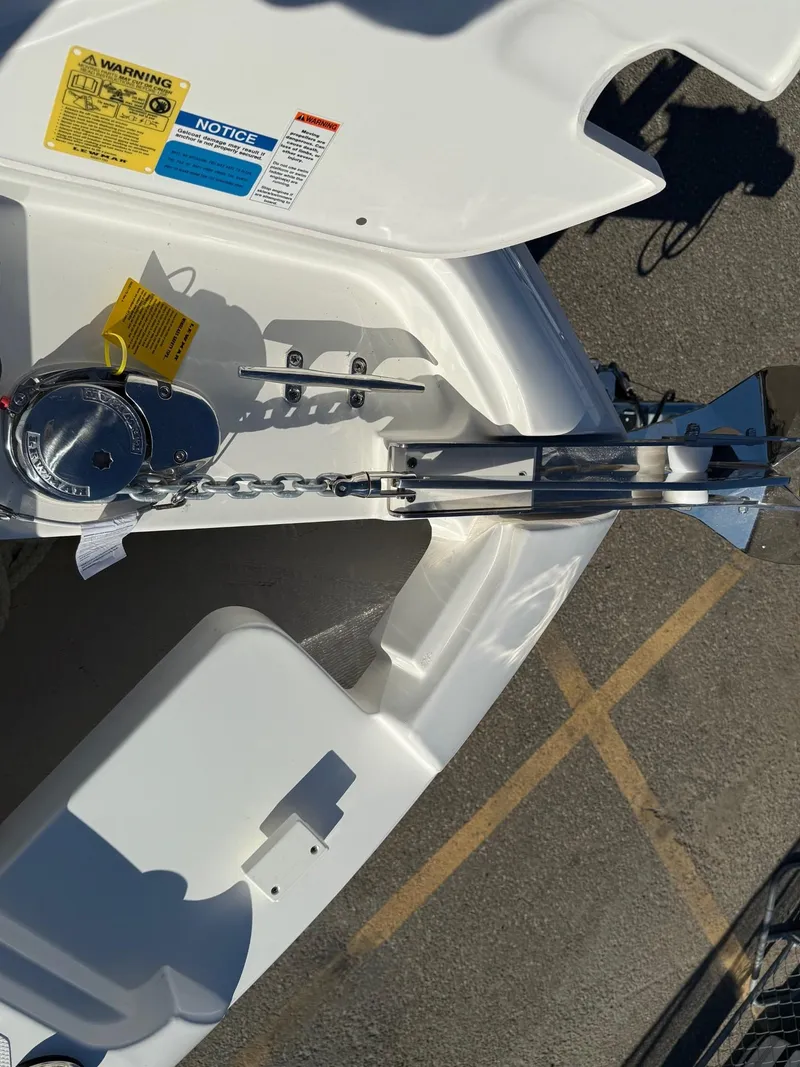 Slide: The Image of 2025 Pursuit DC 246 Dual Console boat anchor and chain mechanism. - 16
