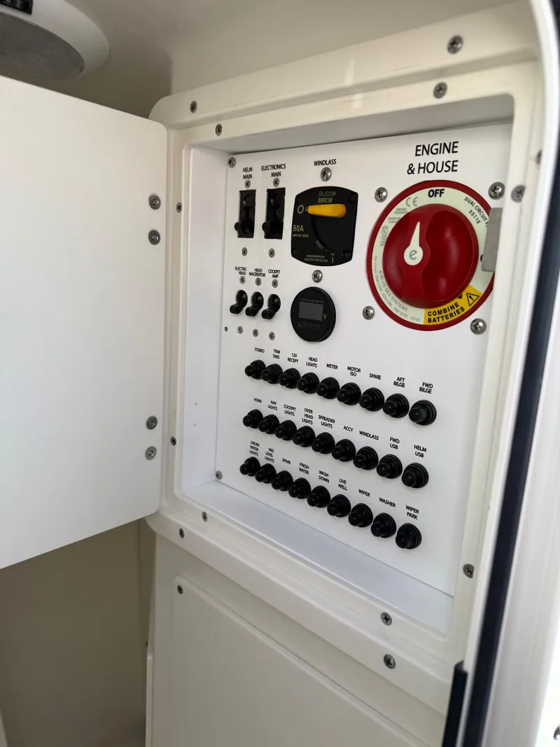 Slide: The Image of Control panel of 2025 Pursuit DC 246 Dual Console boat, featuring engine and house switches. - 19
