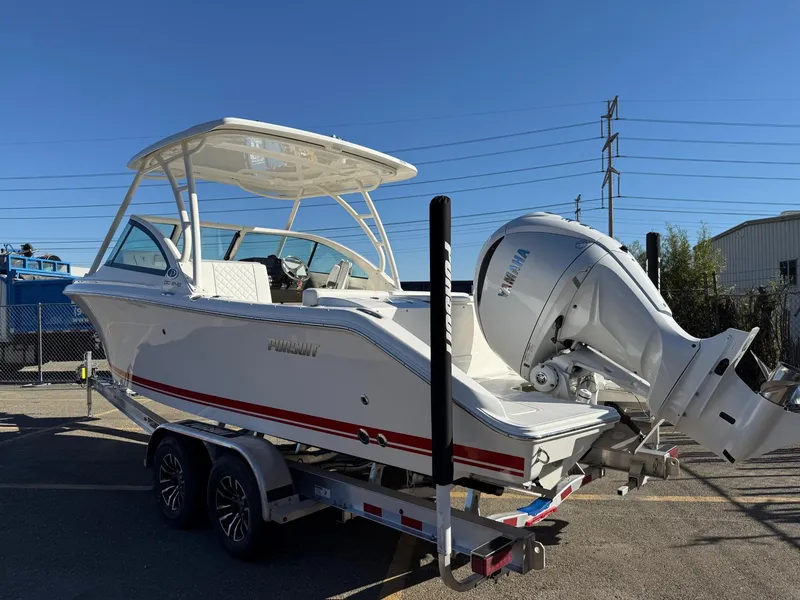 Slide: The Image of 2025 Pursuit DC 246 Dual Console boat on trailer, featuring Yamaha outboard motor. - 2