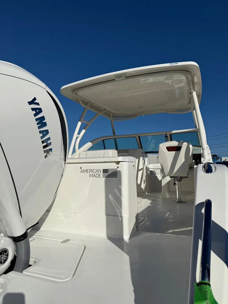 Slide: The Image of 2025 Pursuit DC 246 Dual Console boat with Yamaha engine, showcasing sleek design and spacious deck. - 22