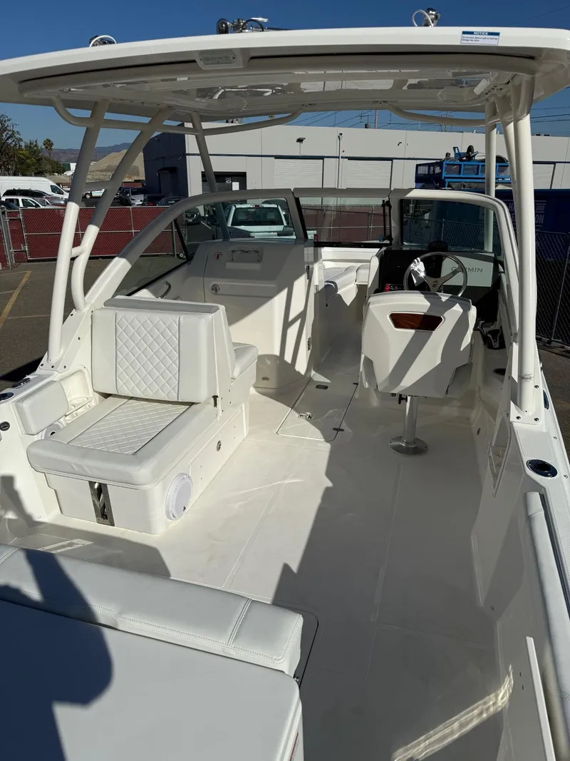 Slide: The Image of 2025 Pursuit DC 246 Dual Console boat with spacious seating and modern design. - 5