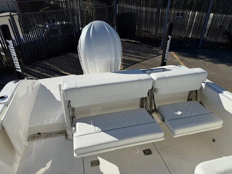 Slide: The Image of 2025 Pursuit DC 246 Dual Console boat with white seating and outboard motor. - 6