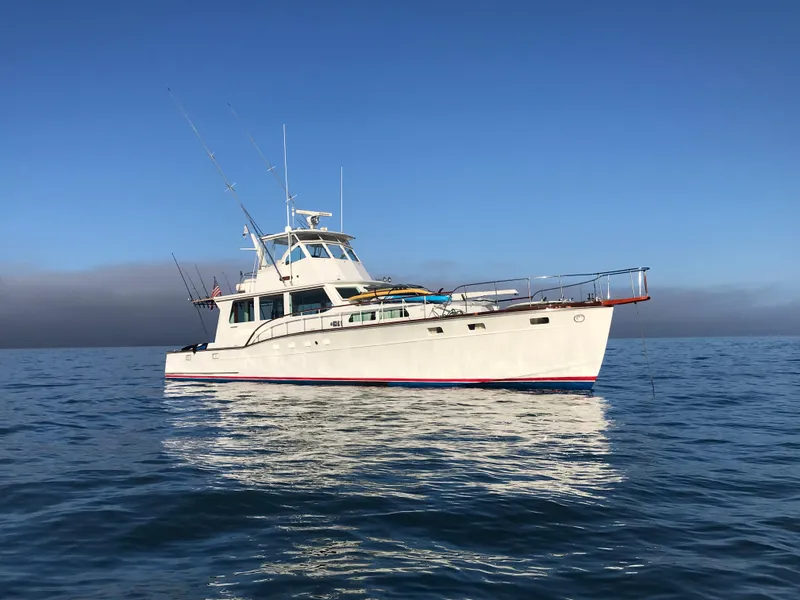 Slide: The Image of 1966 Huckins Sportsman boat on calm ocean under clear blue sky. - 0