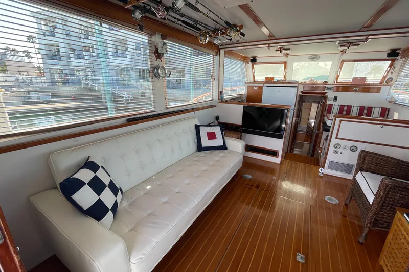 Slide: The Image of Interior of a 1966 Huckins Sportsman boat with elegant seating and wood flooring. - 10