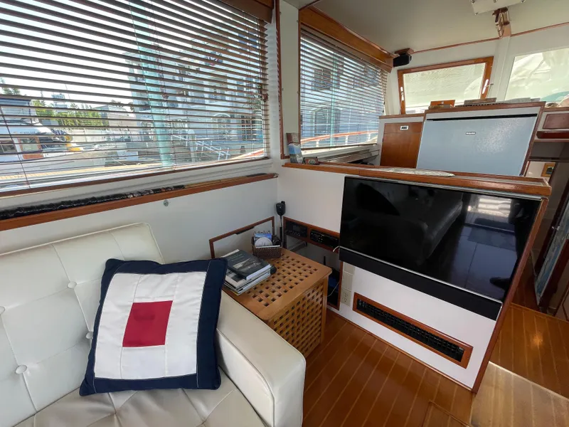 Slide: The Image of Interior of a 1966 Huckins Sportsman boat with modern furnishings and large windows. - 11