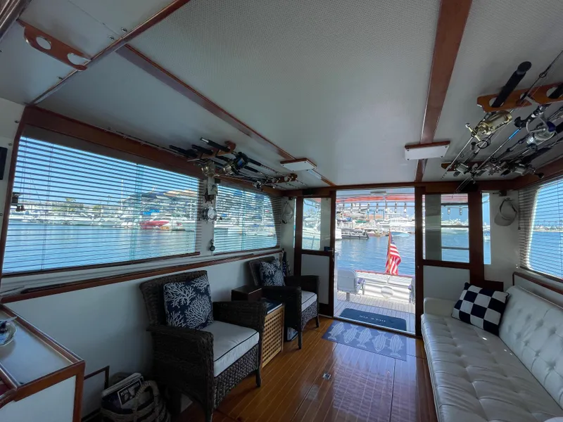 Slide: The Image of Interior of a 1966 Huckins Sportsman boat with seating and fishing rods. - 13