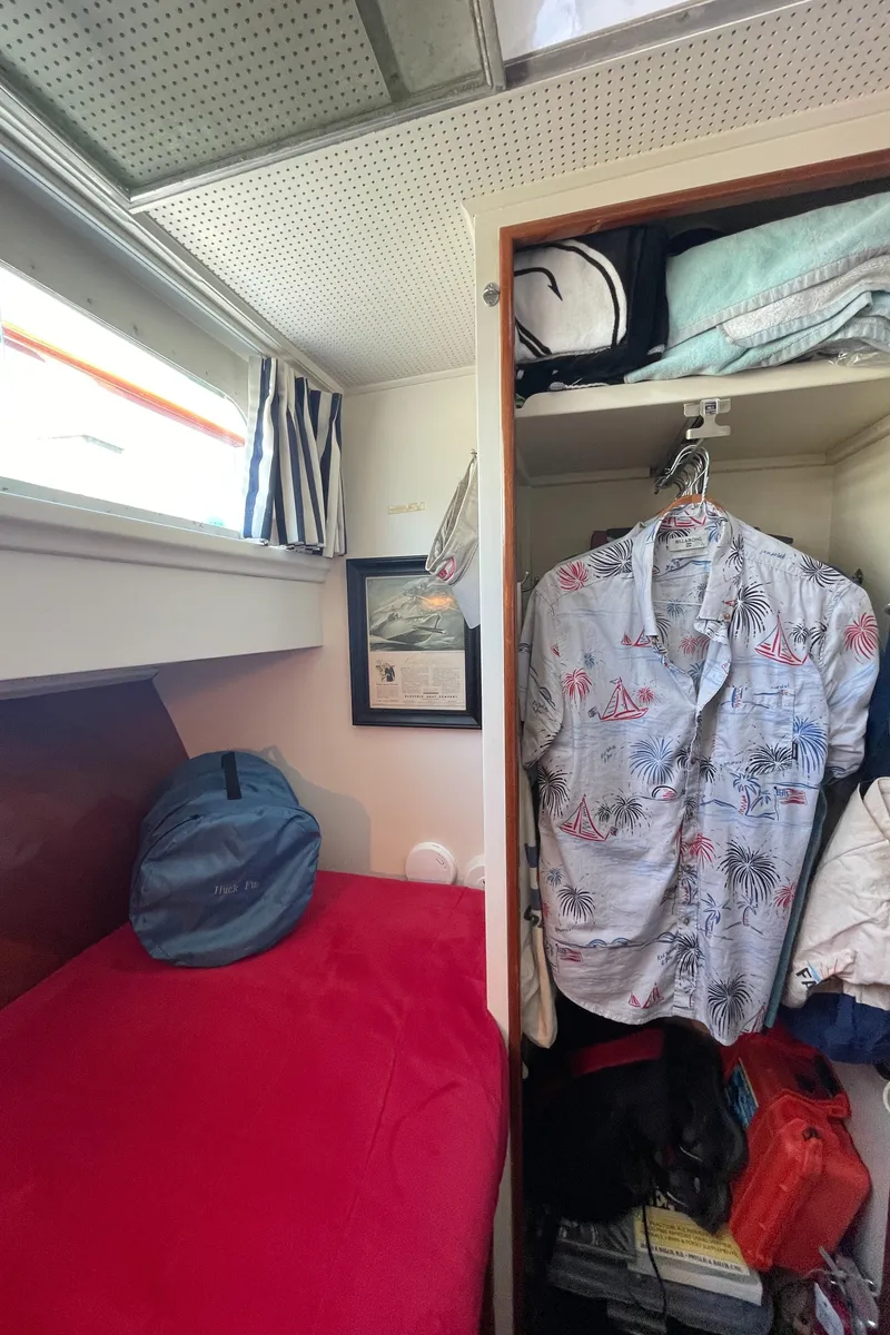 Slide: The Image of 1966 Huckins Sportsman cabin with bed, closet, and nautical decor. - 39