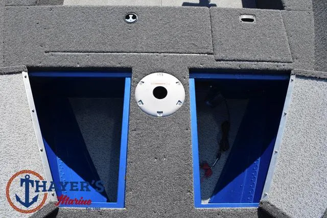 Slide: The Image of 2024 Lund 1650 Angler Tiller boat interior with storage compartments, Thayer's Marine logo. - 12