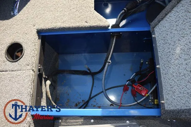 Slide: The Image of 2024 Lund 1650 Angler Tiller boat storage compartment with wiring and marine carpet. - 20