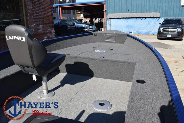 Slide: The Image of 2024 Lund 1650 Angler Tiller boat interior with seating and storage compartments. - 22