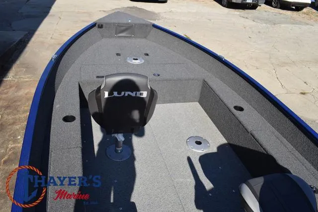 Slide: The Image of 2024 Lund 1650 Angler Tiller boat interior with seating and storage compartments. - 23
