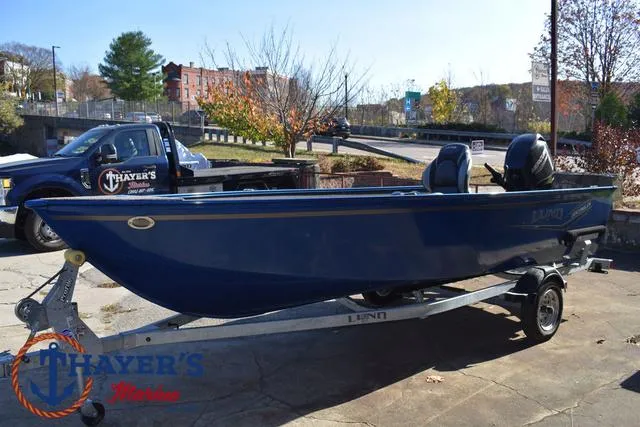 Slide: The Image of 2024 Lund 1650 Angler Tiller boat on trailer at Thayer's Marine dealership. - 7