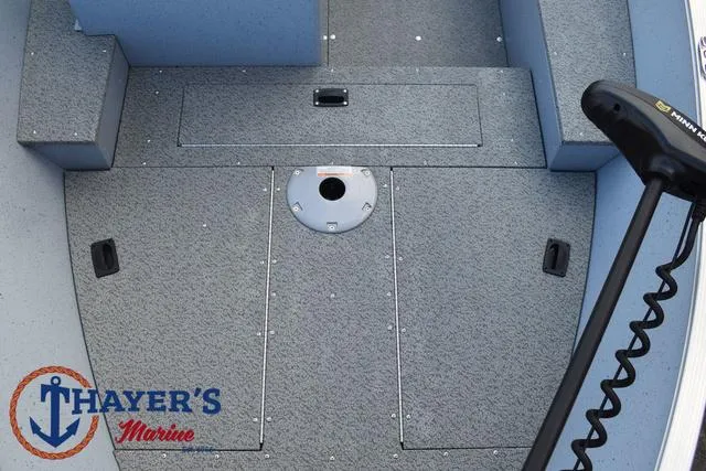 Slide: The Image of 2024 Lund 1600 Fury SS boat interior with storage compartments and trolling motor. - 11