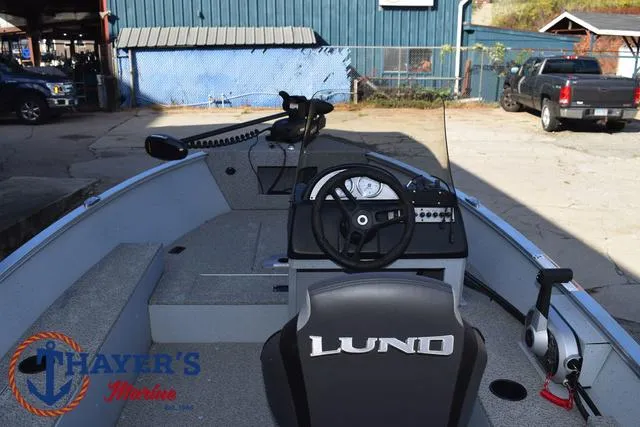 Slide: The Image of 2024 Lund 1600 Fury SS boat interior with steering console and seating. - 23