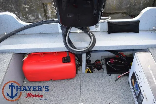 Slide: The Image of 2024 Lund 1600 Fury SS boat interior with red fuel tank and electronics. - 24