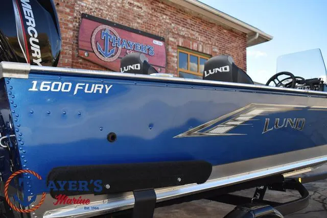 Slide: The Image of 2024 Lund 1600 Fury SS boat in blue, displayed at Thayer's Marine. - 26