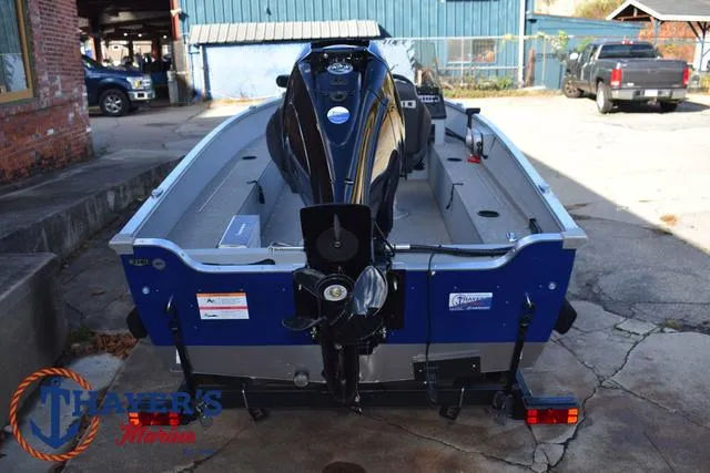 Slide: The Image of 2024 Lund 1600 Fury SS boat, rear view, parked outdoors. - 9