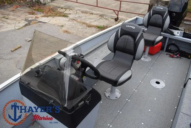 Slide: The Image of 2024 Lund 1600 Fury SS boat interior with steering console and seating. - 15