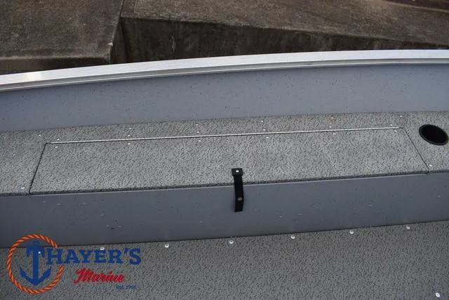 Slide: The Image of 2024 Lund 1600 Fury SS boat interior with storage compartment and Thayer's Marine logo. - 17