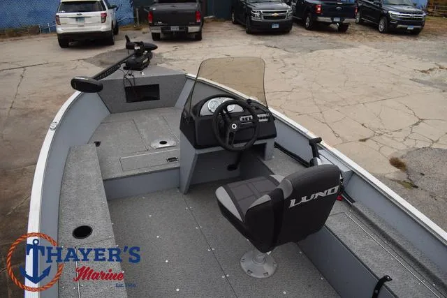 Slide: The Image of 2024 Lund 1600 Fury SS fishing boat interior with steering console and seating. - 22