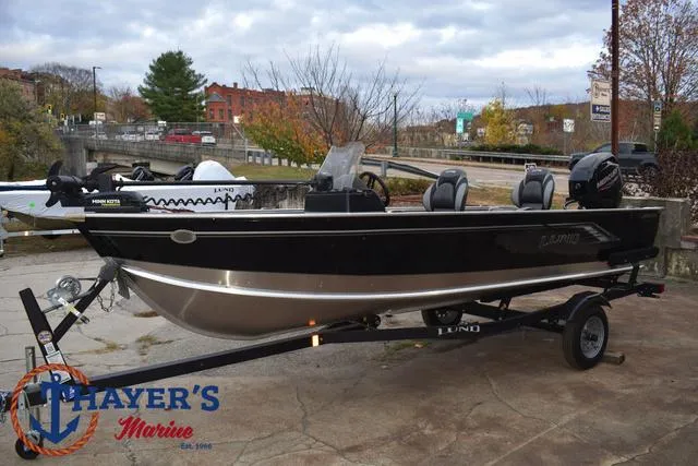Slide: The Image of 2024 Lund 1600 Fury SS fishing boat on trailer, parked outdoors. - 8