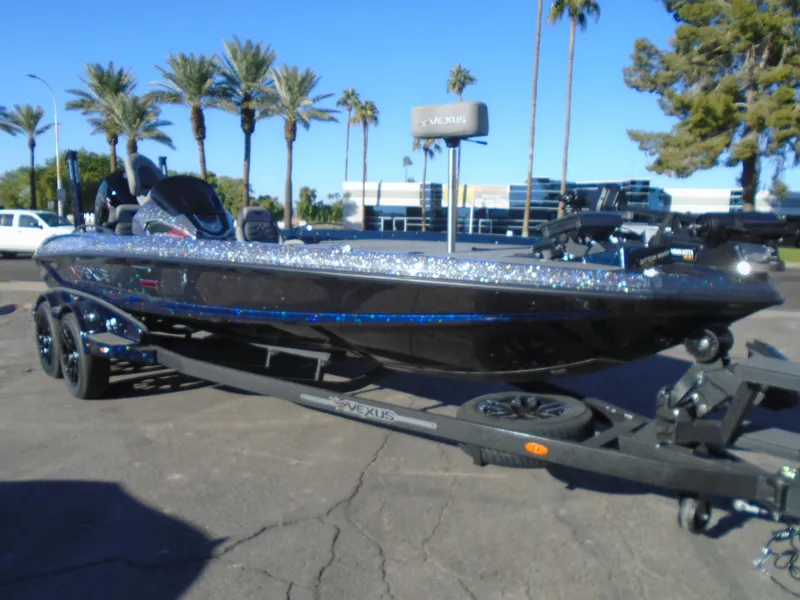 The Image of 2025 Vexus VX21 boat on trailer, parked outdoors with palm trees in the background. - 1