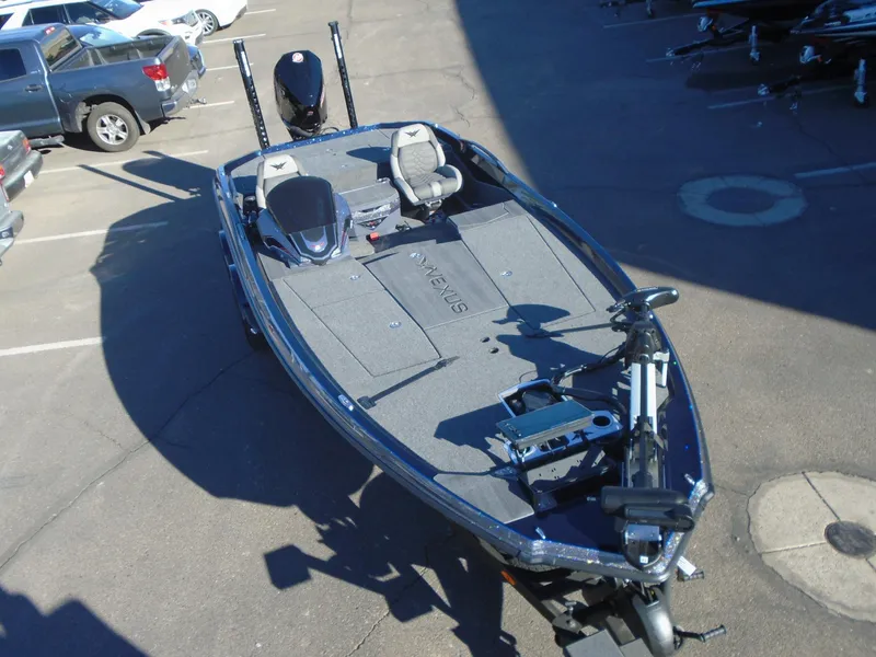 Slide: The Image of 2025 Vexus VX21 fishing boat in a parking lot, featuring spacious deck and seating. - 11