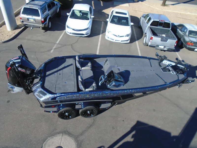 Slide: The Image of 2025 Vexus VX21 boat in parking lot, surrounded by cars and trucks. - 14