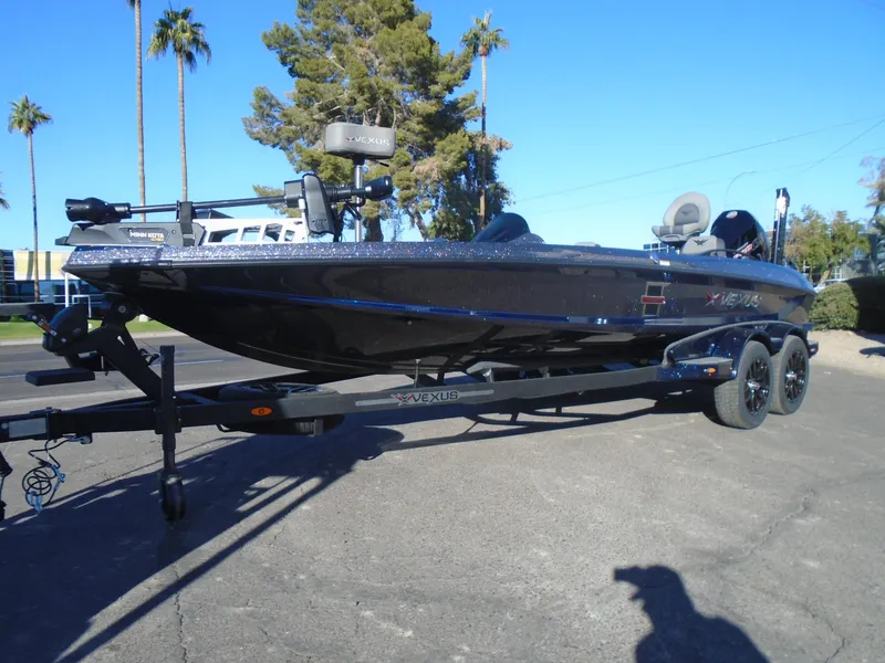 Slide: The Image of 2025 Vexus VX21 boat on trailer, parked outdoors with palm trees in background. - 20