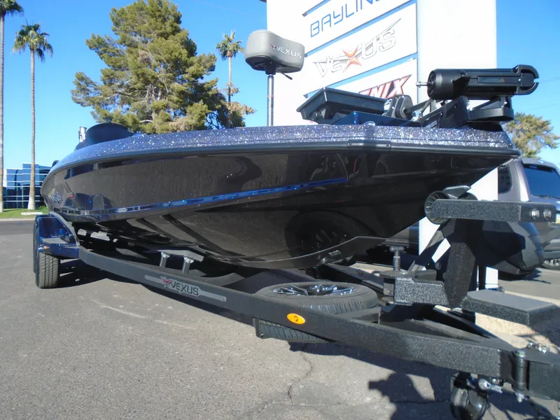 Slide: The Image of 2025 Vexus VX21 boat on trailer, parked outdoors under clear blue sky. - 21