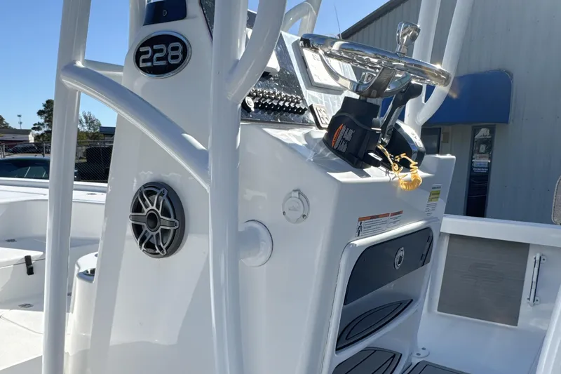 Slide: The Image of 2023 Sea Pro 228 Bay boat console with steering wheel and controls. - 12