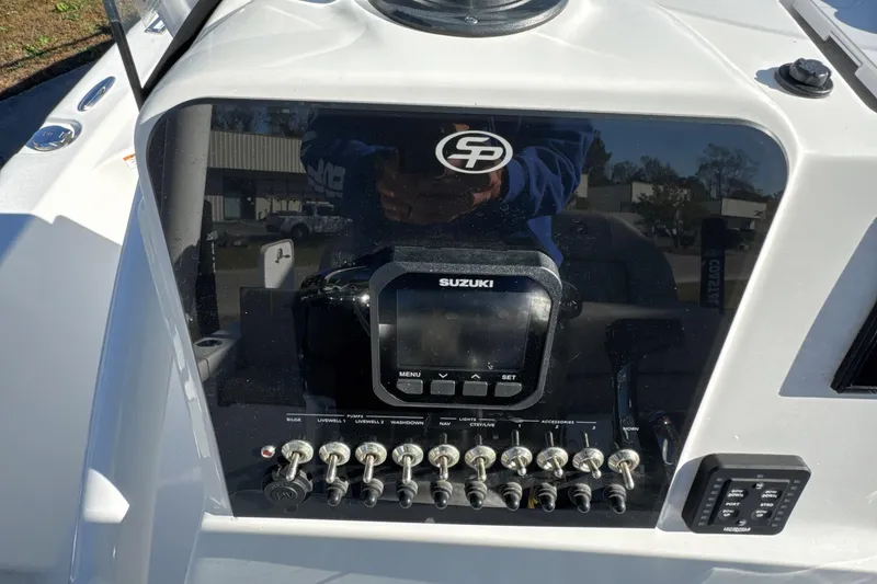 Slide: The Image of 2023 Sea Pro 228 Bay boat dashboard with Suzuki controls and switches. - 14