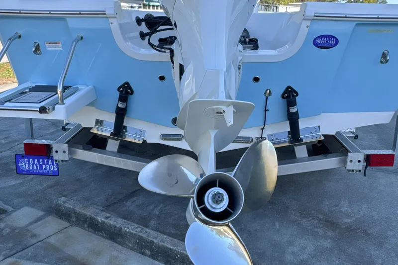 Slide: The Image of 2023 Sea Pro 228 Bay boat rear view with propeller and trailer. - 23