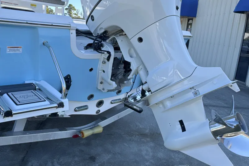 Slide: The Image of 2023 Sea Pro 228 Bay boat with outboard motor, blue and white design. - 24