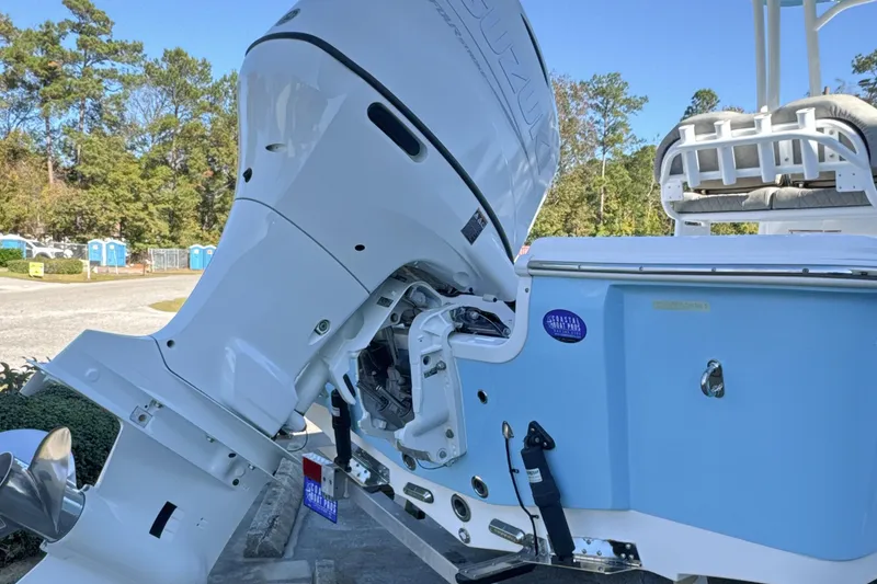 Slide: The Image of 2023 Sea Pro 228 Bay boat with powerful outboard motor, parked outdoors. - 25